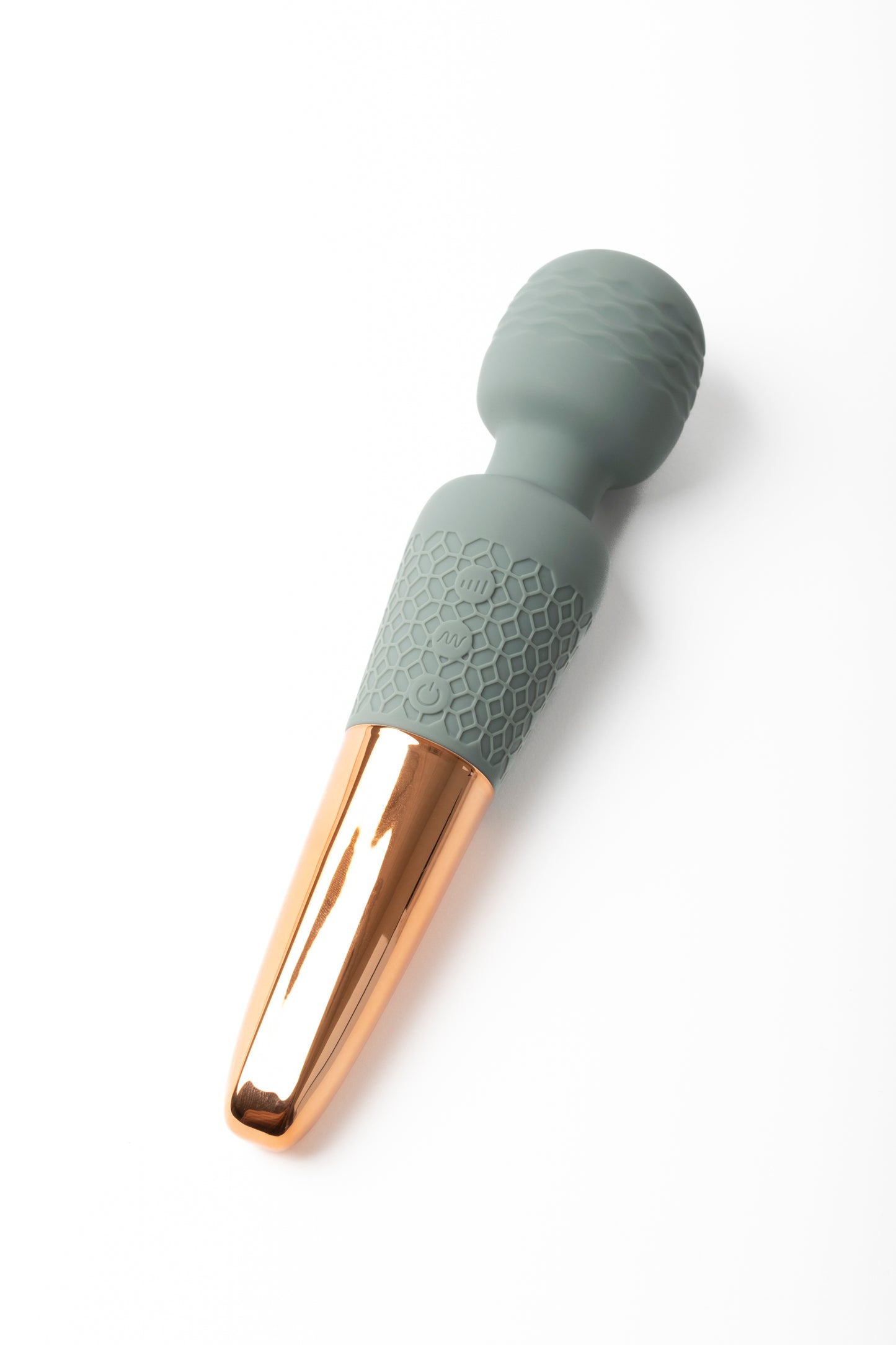 Soft, waterproof personal wellness massager with a textured silicone handle and gold-toned base, designed for gentle relaxation and everyday self-care.