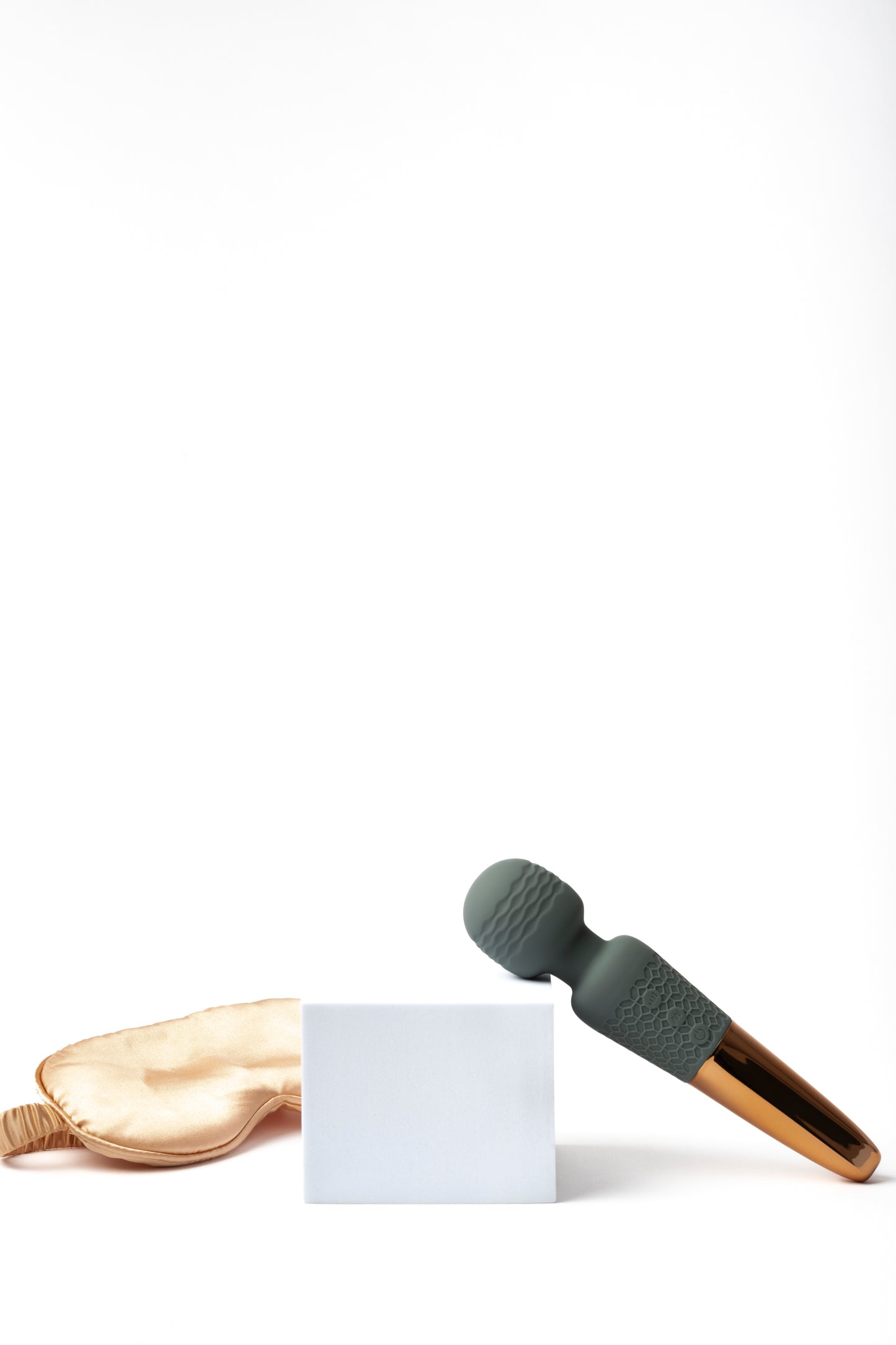 Soft, waterproof personal wellness massager with a textured silicone handle and gold-toned base, designed for gentle relaxation and everyday self-care.